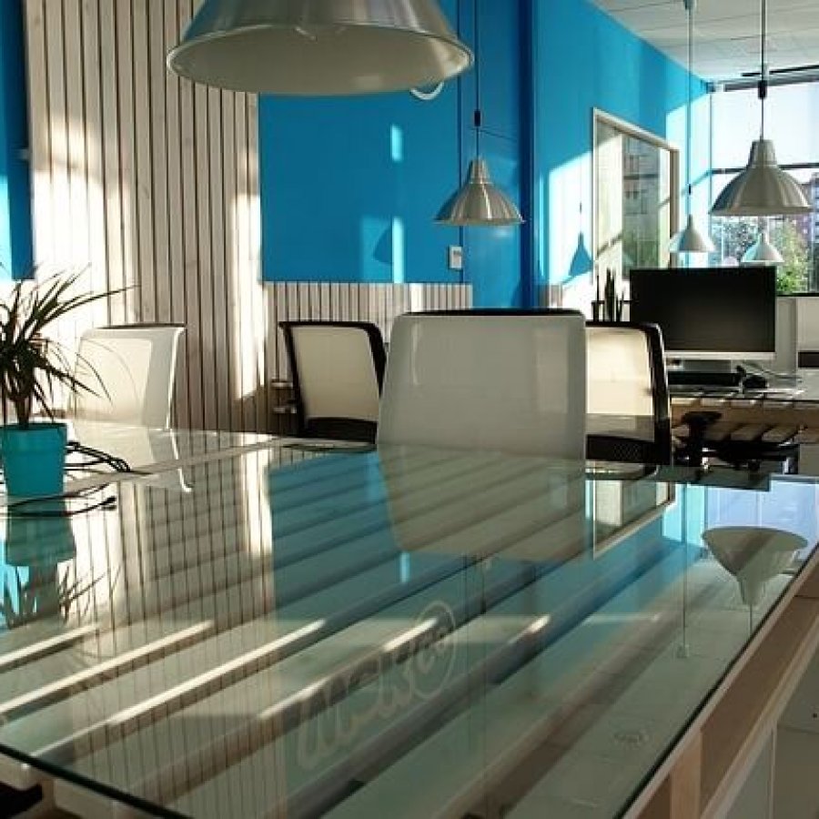 office with glass tables and blue walls